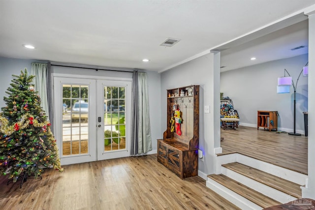 doorway to outside featuring crown molding, french doors, and light hardwood / wood-style flooring