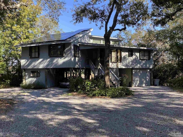 view of front of home with solar panels and a garage