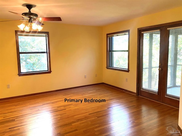 spare room featuring ceiling fan, french doors, and hardwood / wood-style flooring