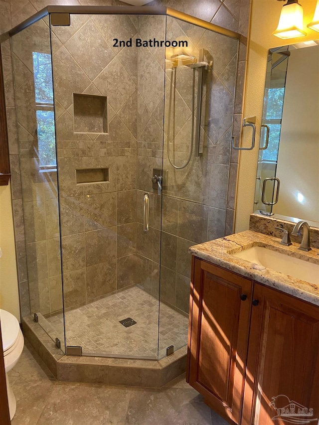 bathroom with vanity, toilet, and walk in shower