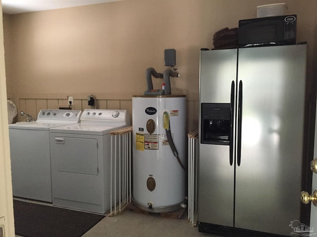 laundry room with washer and clothes dryer and water heater