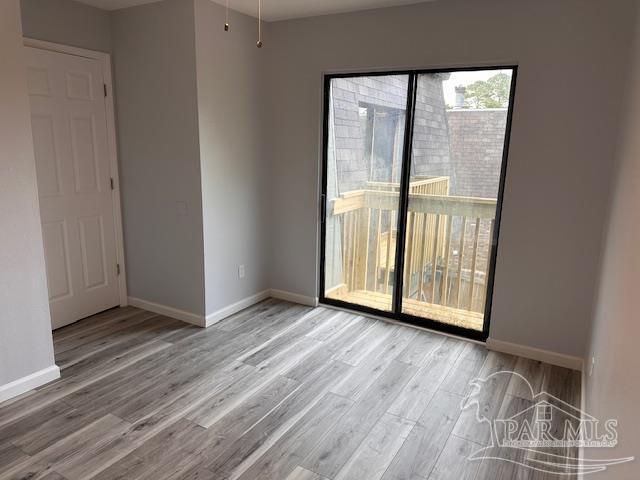 2301 W Michigan Ave Unit 25, Pensacola, FL 32526 - unfurnished room with wood finished floors and baseboards