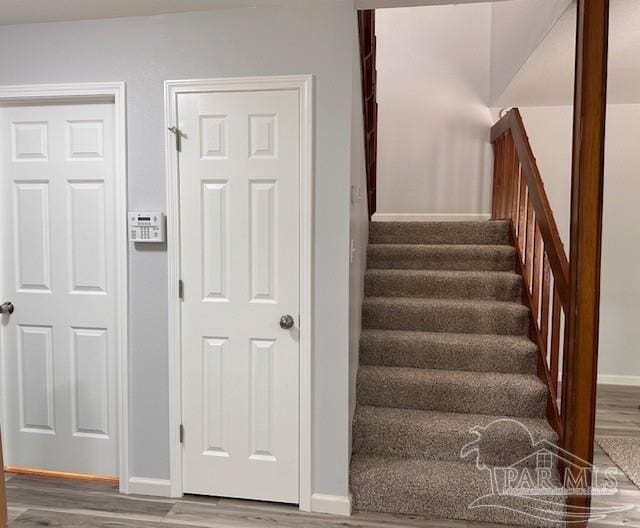 2301 W Michigan Ave Unit 25, Pensacola, FL 32526 - stairway with wood finished floors and baseboards