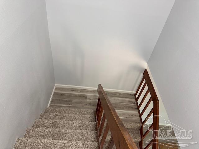 2301 W Michigan Ave Unit 25, Pensacola, FL 32526 - staircase with wood finished floors and baseboards