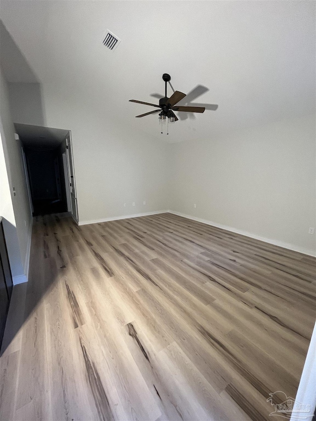 unfurnished living room featuring ceiling fan and hardwood / wood-style flooring