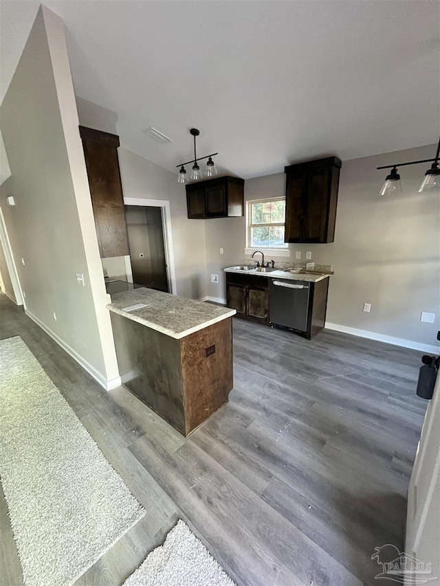 kitchen featuring hardwood / wood-style floors, sink, vaulted ceiling, stainless steel dishwasher, and dark brown cabinets