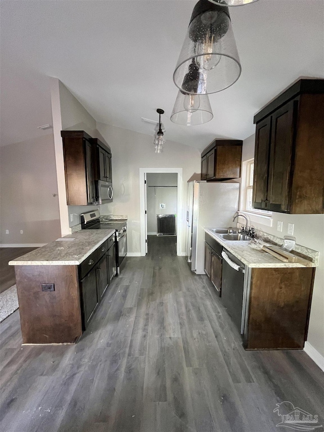 kitchen featuring appliances with stainless steel finishes, dark brown cabinets, and lofted ceiling