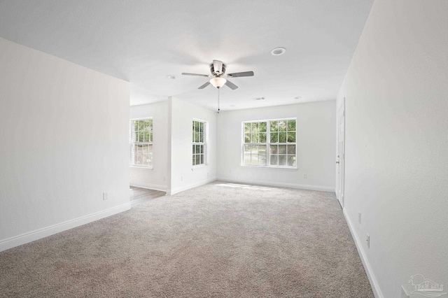 unfurnished room with ceiling fan and light carpet