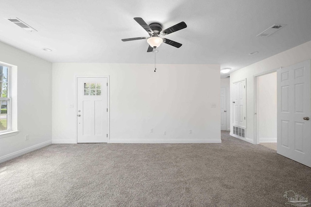 spare room with visible vents, baseboards, carpet, and ceiling fan