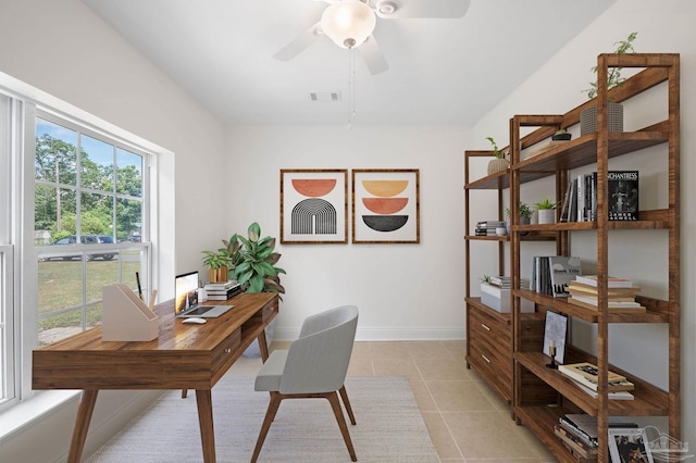 office space featuring a ceiling fan, light tile patterned floors, baseboards, and visible vents