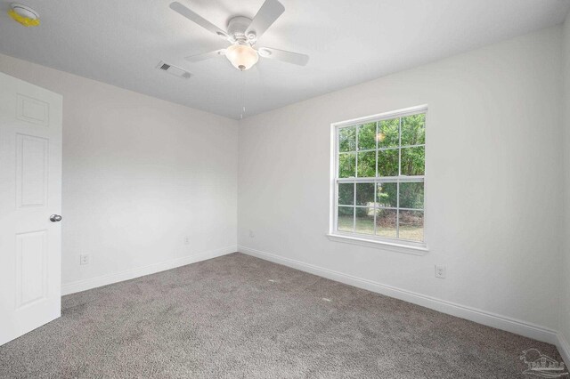 empty room with ceiling fan and carpet