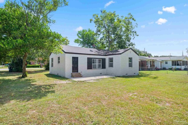 rear view of house featuring a yard