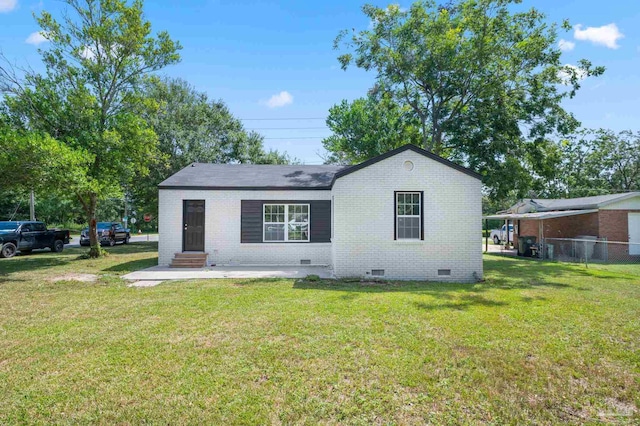 view of front of house featuring brick siding, fence, entry steps, a front yard, and crawl space