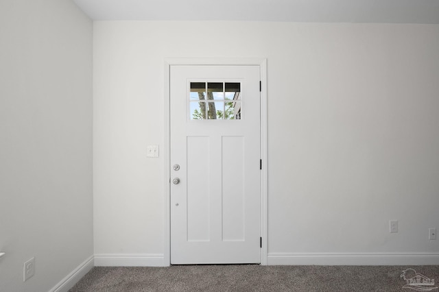 view of carpeted foyer entrance