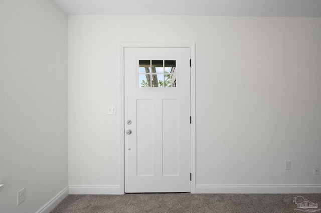 carpeted entryway featuring baseboards