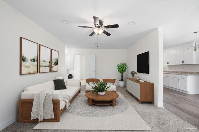 living room with ceiling fan and light hardwood / wood-style floors