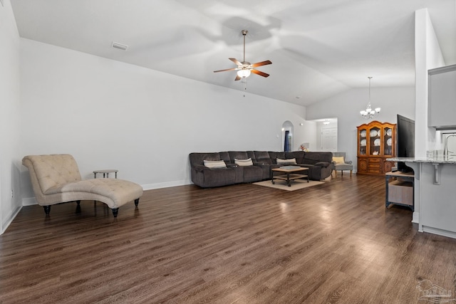 living room featuring ceiling fan with notable chandelier, dark hardwood / wood-style floors, and lofted ceiling