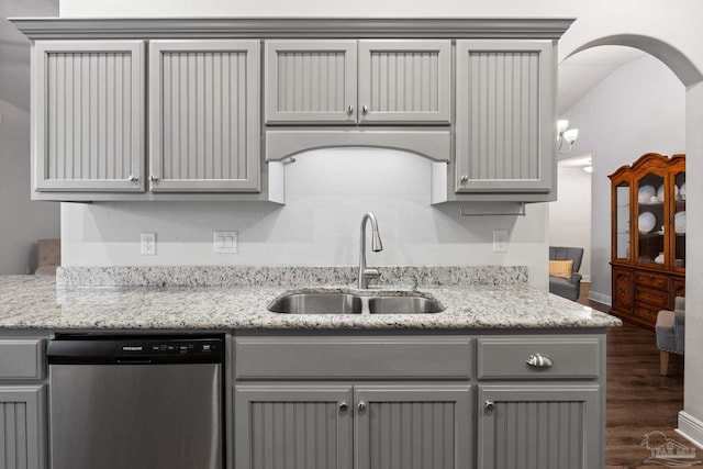 kitchen with gray cabinetry, dishwasher, dark wood-type flooring, sink, and light stone counters