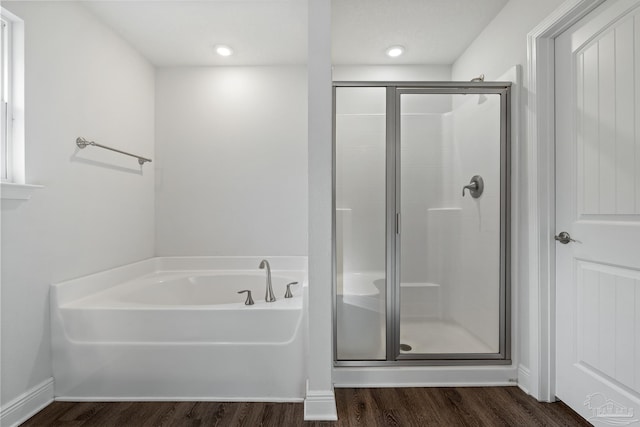 bathroom with separate shower and tub and hardwood / wood-style floors