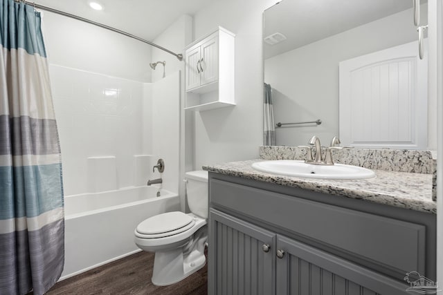 full bathroom with vanity, hardwood / wood-style flooring, toilet, and shower / bathtub combination with curtain