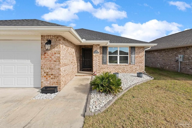 doorway to property featuring a garage and a yard