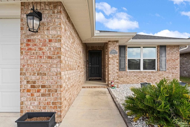 doorway to property with a garage