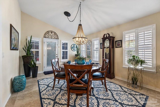 dining space with vaulted ceiling, an inviting chandelier, and baseboards