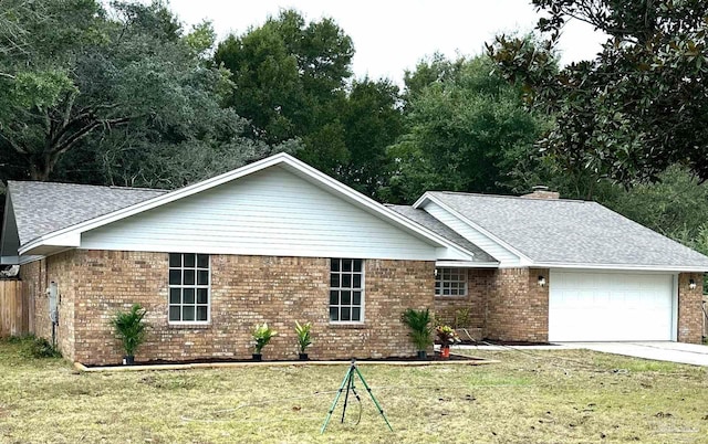 ranch-style home featuring a front lawn and a garage