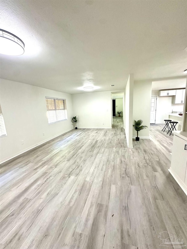 basement with a textured ceiling and light wood-type flooring