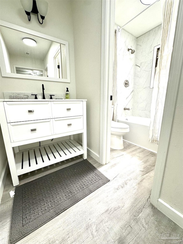 full bathroom with toilet, vanity, shower / tub combo, and hardwood / wood-style flooring