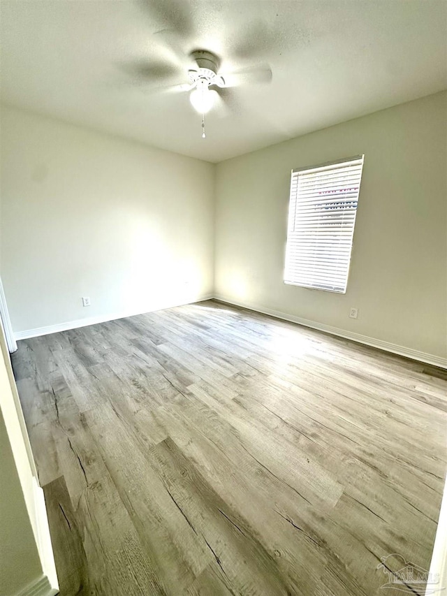 unfurnished room with light wood-type flooring and ceiling fan