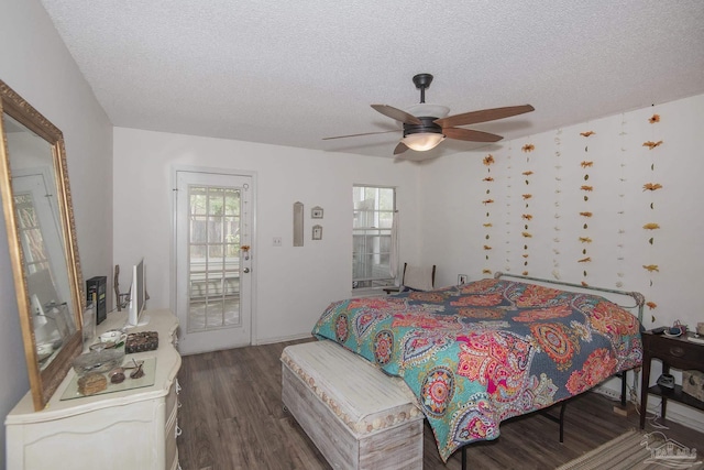 bedroom with ceiling fan, access to outside, dark hardwood / wood-style floors, and a textured ceiling