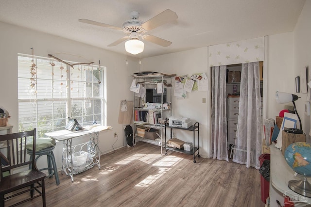 interior space featuring hardwood / wood-style floors, a textured ceiling, and ceiling fan