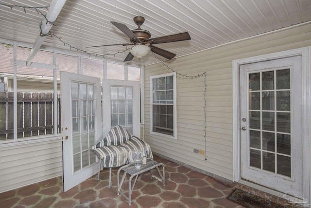 sunroom featuring wood ceiling and ceiling fan