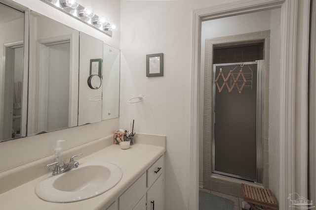 bathroom featuring vanity and a shower with door