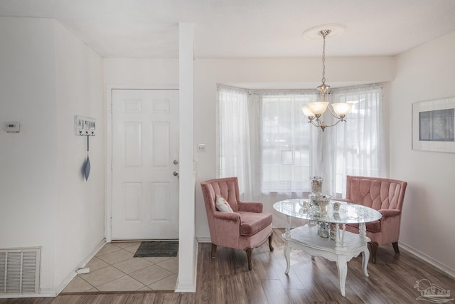 dining area with a notable chandelier and hardwood / wood-style flooring