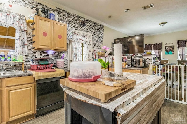 kitchen with tasteful backsplash, light brown cabinetry, ornamental molding, light hardwood / wood-style floors, and sink