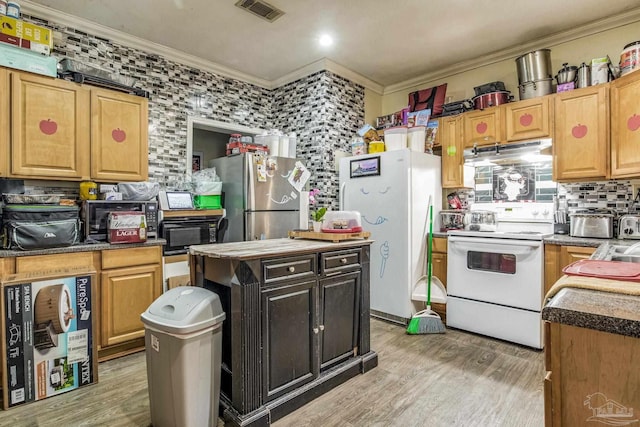 kitchen with white appliances, ornamental molding, light hardwood / wood-style flooring, and a kitchen island