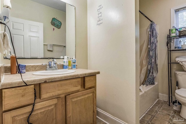 full bathroom with vanity, shower / bath combo, and toilet