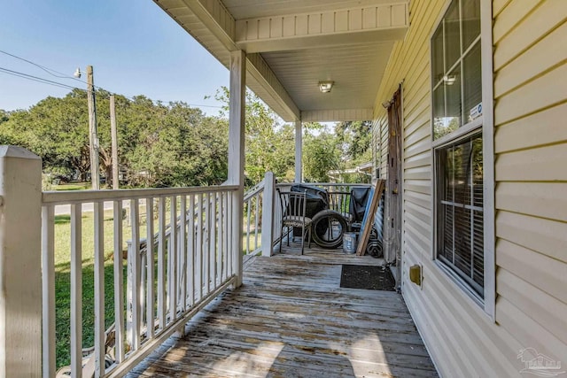 wooden terrace featuring covered porch