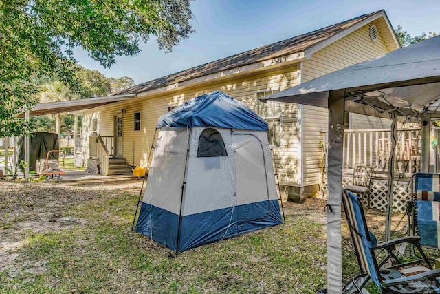 view of home's exterior with a gazebo and a storage shed