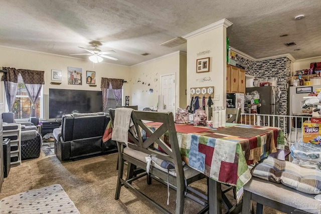 carpeted dining room featuring ornamental molding, a textured ceiling, and ceiling fan