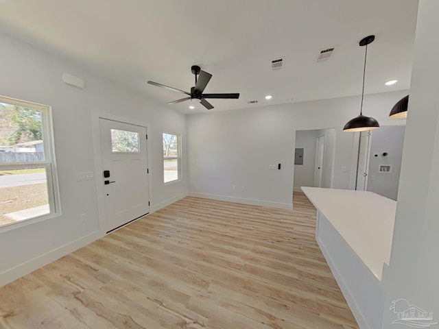 unfurnished living room featuring light wood finished floors, baseboards, visible vents, ceiling fan, and recessed lighting