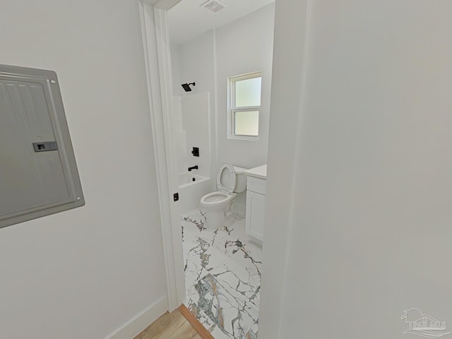 bathroom with bathtub / shower combination, toilet, vanity, baseboards, and electric panel