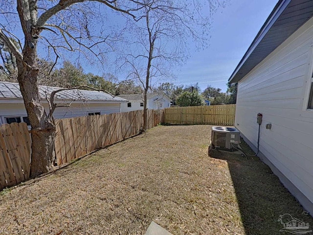 view of yard featuring a fenced backyard and central AC unit