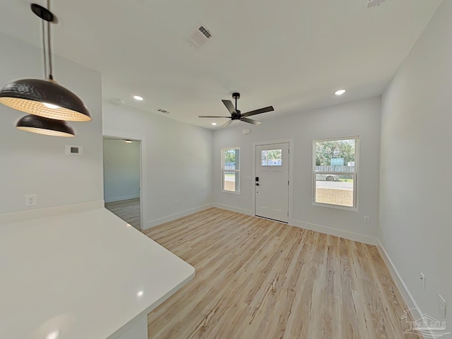 foyer entrance featuring light wood finished floors, baseboards, visible vents, and recessed lighting