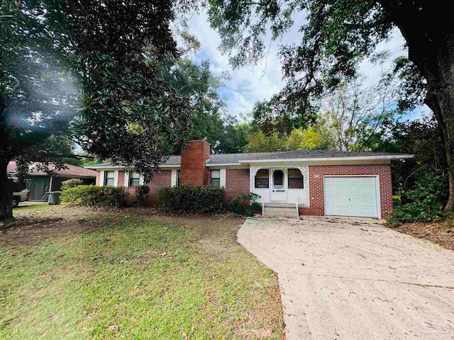 single story home with a front yard and a garage