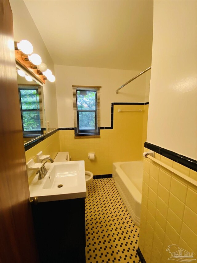 kitchen with stainless steel range with electric cooktop, white refrigerator, and light hardwood / wood-style flooring