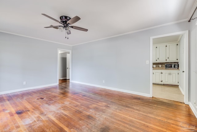 unfurnished room featuring baseboards, light wood-style flooring, a ceiling fan, and ornamental molding