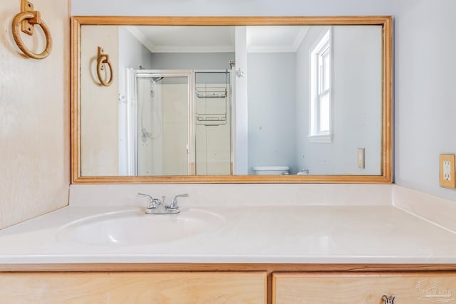 full bath with vanity, a shower stall, toilet, and ornamental molding